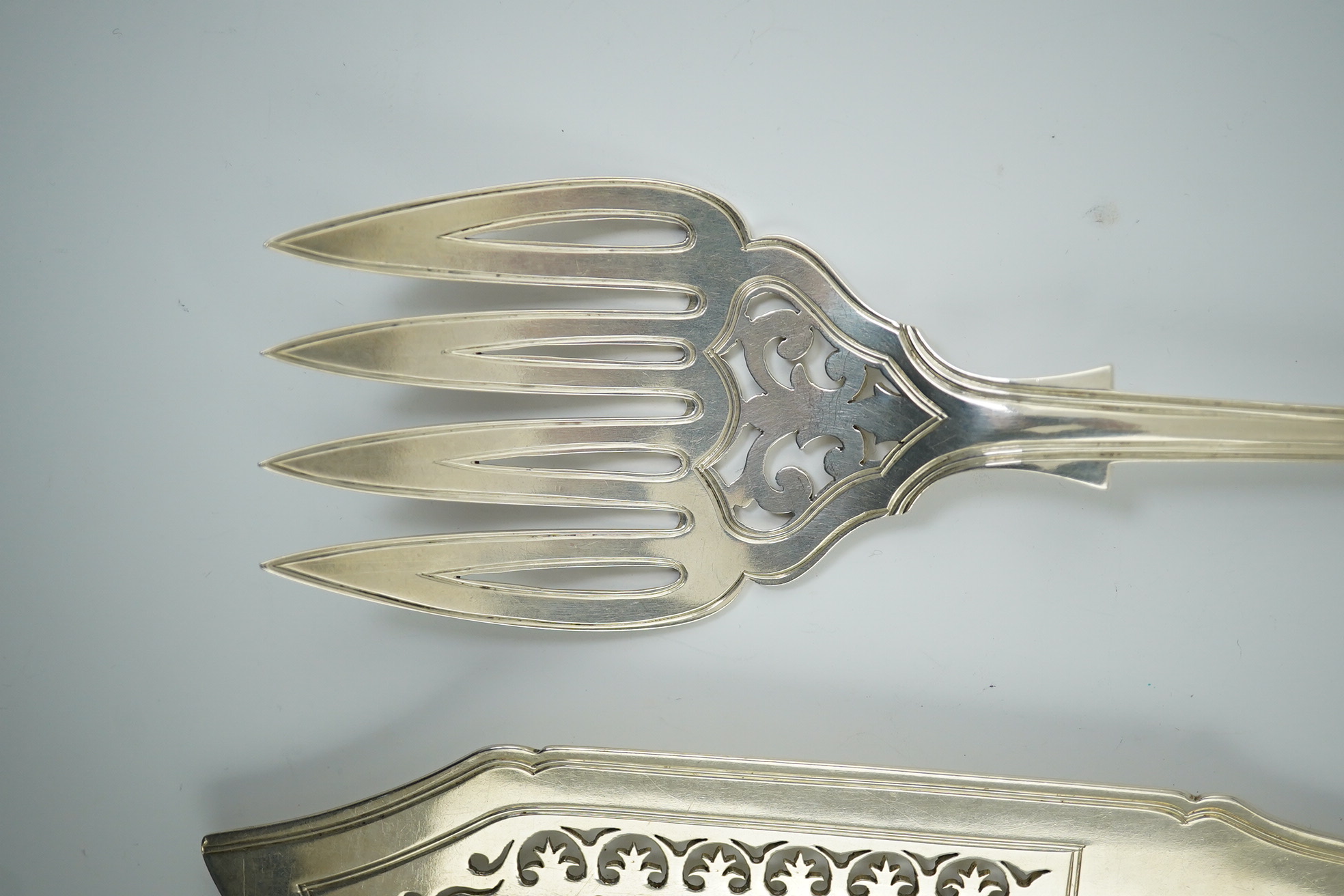 A Victorian silver fiddle, thread and shell pattern fish server and a similar shell pattern fish slice, John James Whiting, London, 1857 and William Eaton, London, 1836 respectively